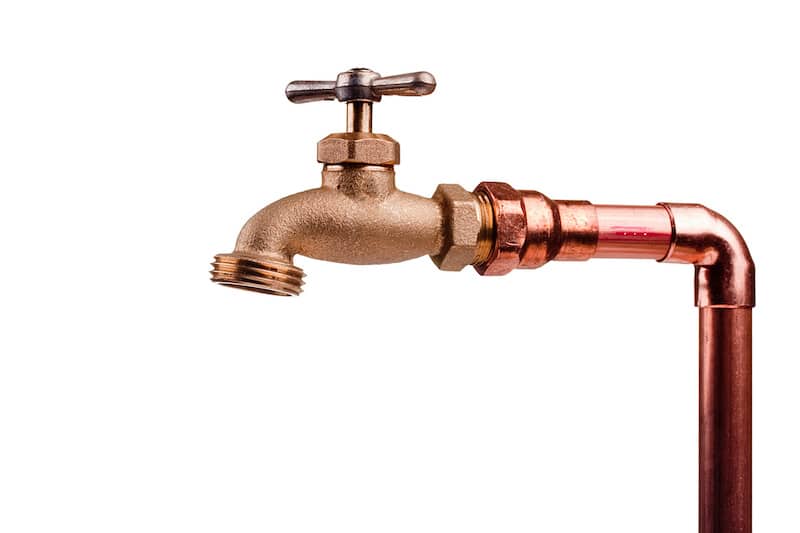 Bronze faucet attached to the water system of copper pipes.