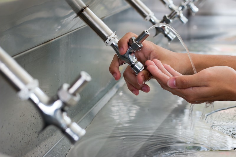 Water cooler for drink use in school. Water taps of drinking water in a public school, Thailand.