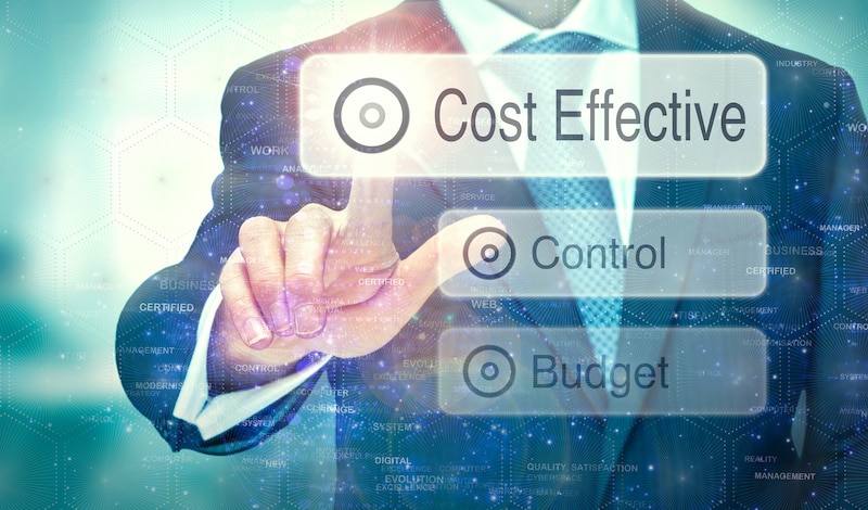 A businessman selecting a button on a futuristic display with a Cost Effective concept written on it.