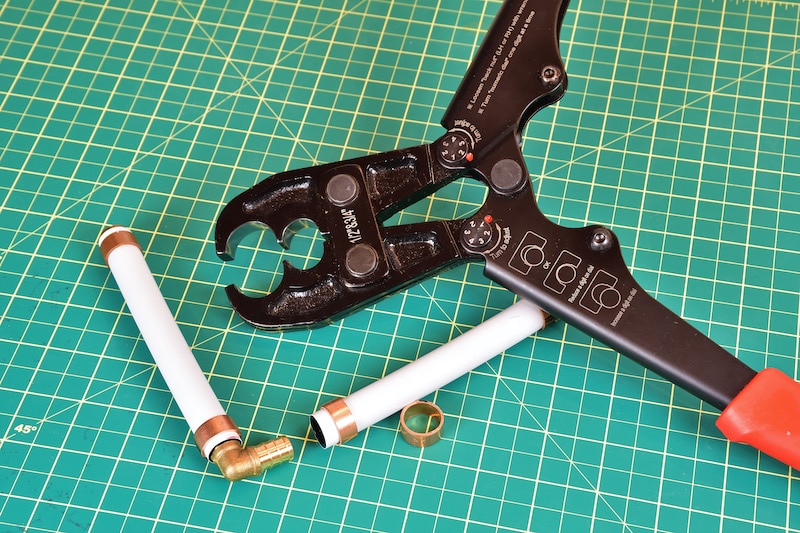 Plumbing tool to connect PEX pipes. Hand plier press for PEX joint. Home improvement plumbing tool. Plastic pipe connector.