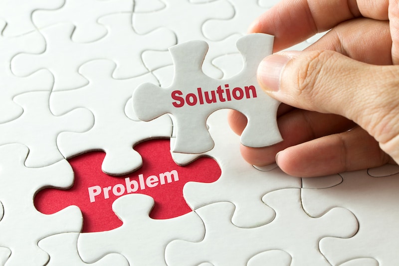 Hand putting last piece of puzzle with the word solution to fix the problem visible plumbing problems