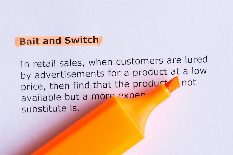 bait and switch word highlighted on the white paper