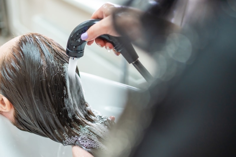 Close up view of washing hair in sink in beauty salon. High quality photo