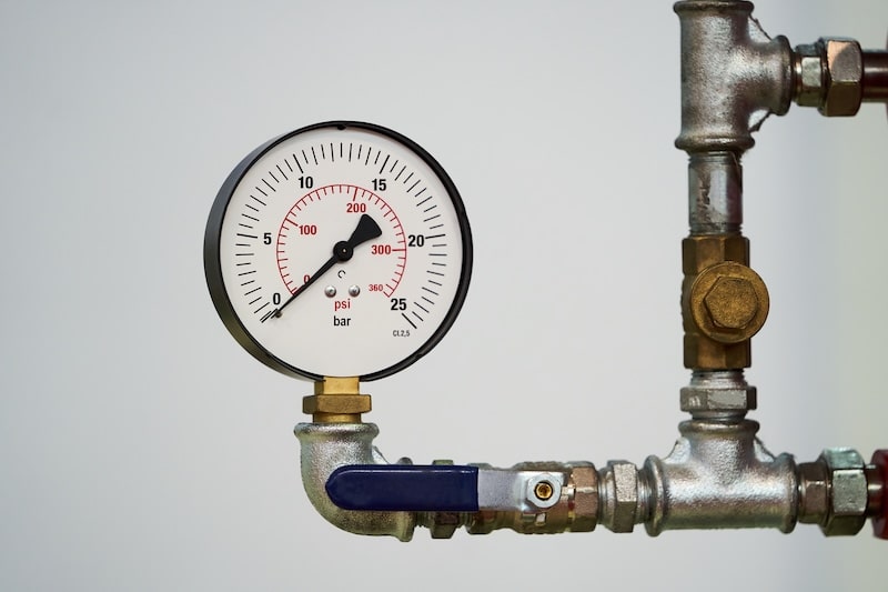 Pressure gauge psi meter on white background with copy space. Pressure meter gauge, close-up