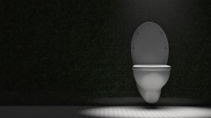 Toilet bowl in the restroom. Dramatic lighting. Copy space