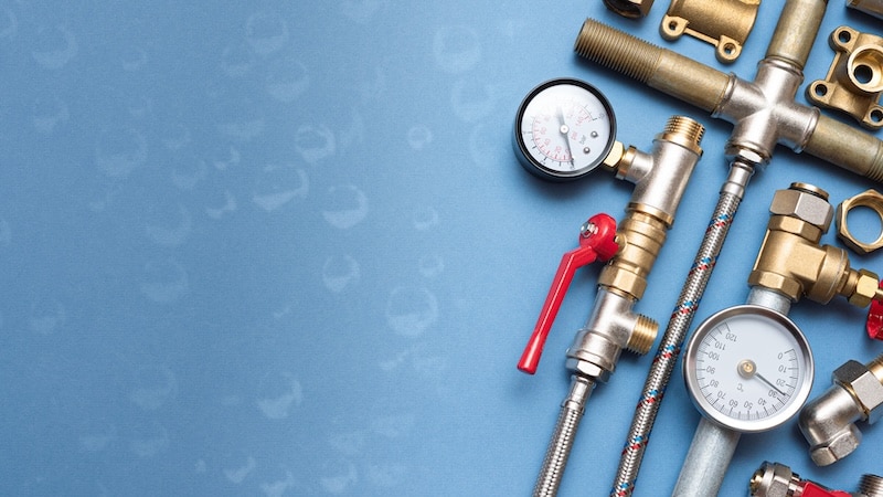 Plumber business card mockup. Plumbing accessories on blue background with copy space.